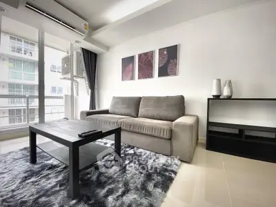 Modern living room with plush sofa, sleek coffee table, and stylish decor in a bright apartment.