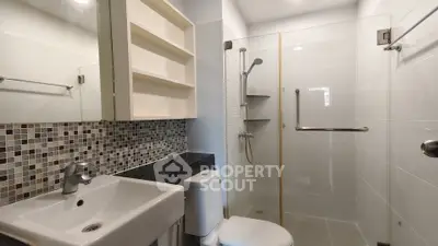 Modern bathroom with sleek shower and stylish mosaic tiles