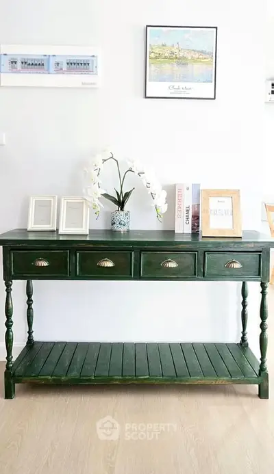 Elegant green console table with decorative accents in a stylish living room.