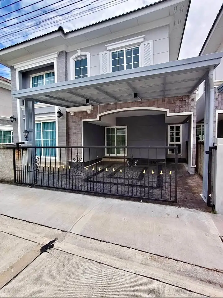 Modern two-story house with covered carport and stylish facade in a suburban neighborhood.