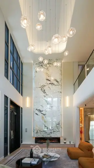 Luxurious modern living room with high ceilings and elegant chandelier lighting