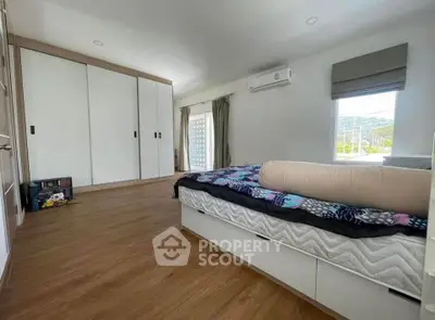 Spacious bedroom with modern design and ample natural light