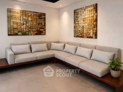 Modern living room with stylish L-shaped sofa and abstract wall art