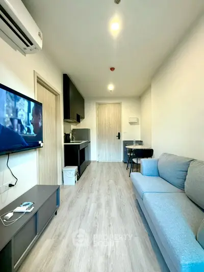 Modern living room with sleek furniture and open kitchen layout