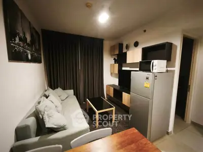 Modern living room with stylish furniture and appliances in a cozy apartment setting.