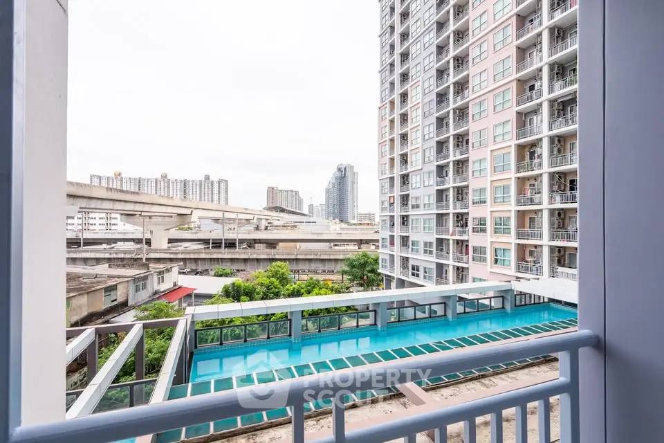 Modern urban apartment view with cityscape and pool, ideal for vibrant city living.