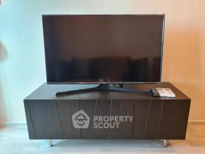 Modern living room with sleek TV stand and flat-screen television