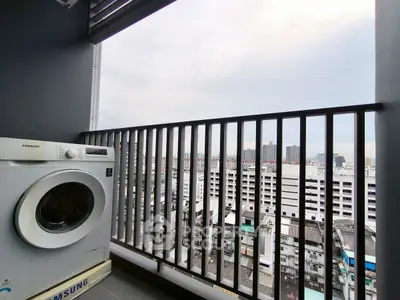 High-rise balcony with city view and washing machine, perfect urban living.