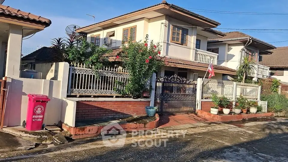 Charming two-story house with lush garden and spacious balcony in a serene neighborhood.