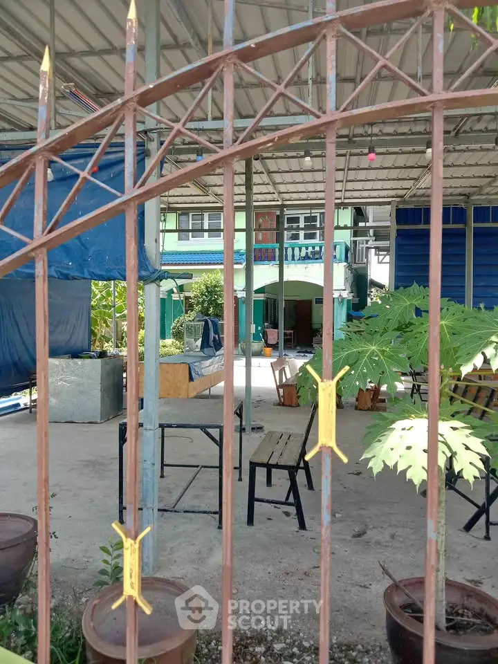 Spacious outdoor area with seating and greenery, perfect for relaxation and gatherings.