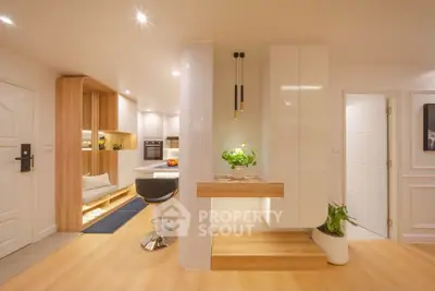 Modern open-layout kitchen with sleek design and stylish lighting