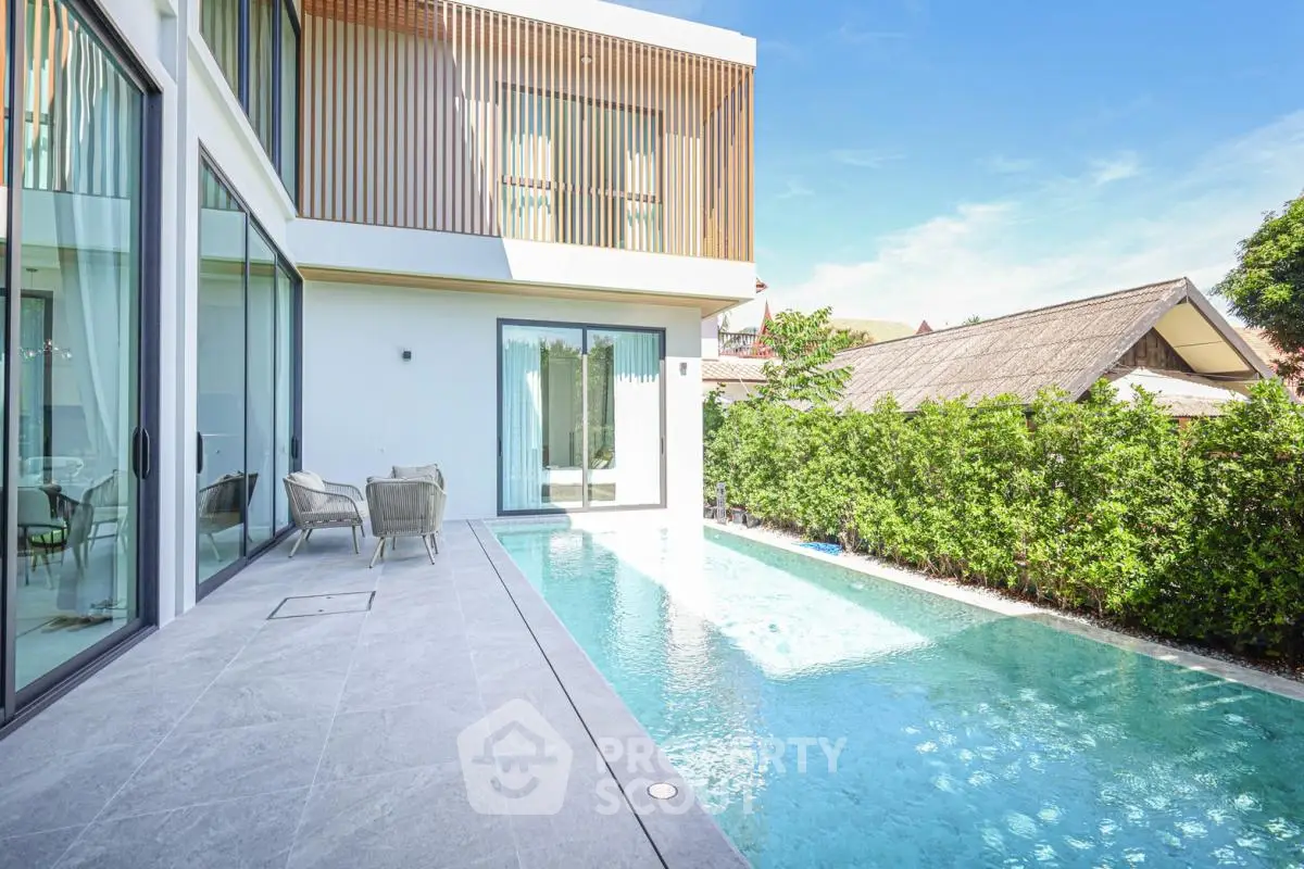 Luxurious modern villa with private pool and stylish outdoor seating area, perfect for relaxation and entertainment.