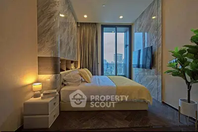 Luxurious bedroom with city view, modern decor, and elegant lighting.