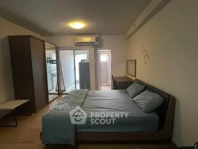 Spacious bedroom with modern furnishings and ample natural light in a stylish apartment.