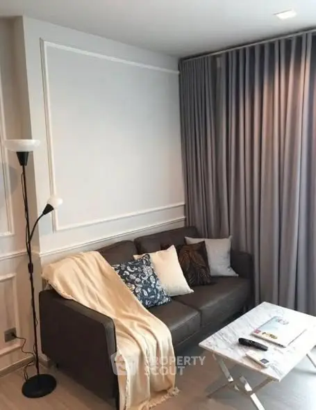 Cozy living room with stylish sofa and elegant curtains