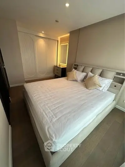 Spacious bedroom with modern design and cozy ambiance, featuring a comfortable bed and stylish decor.