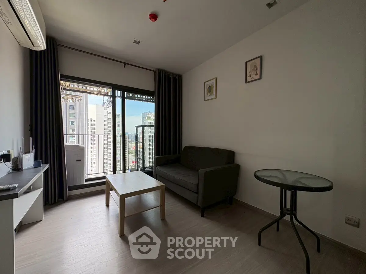 Modern living room with balcony view in high-rise apartment