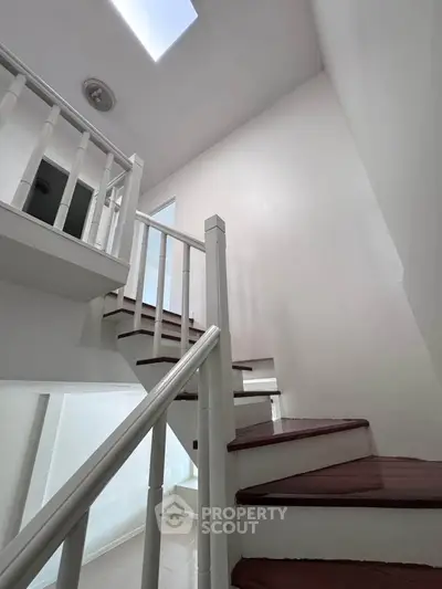 Elegant staircase with skylight in modern home interior