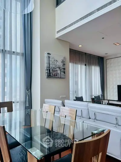 Modern living room with high ceilings and elegant decor in a luxury apartment.
