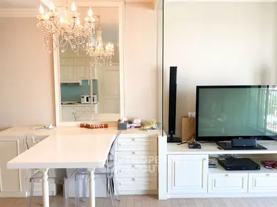 Elegant living room with chandelier and modern entertainment setup