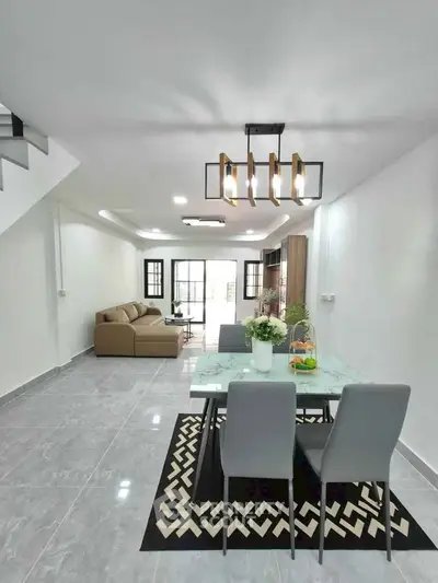 Modern open-plan living and dining area with stylish decor and ample natural light.