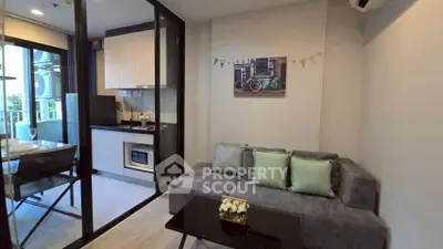 Modern living room with glass partition and cozy kitchen area