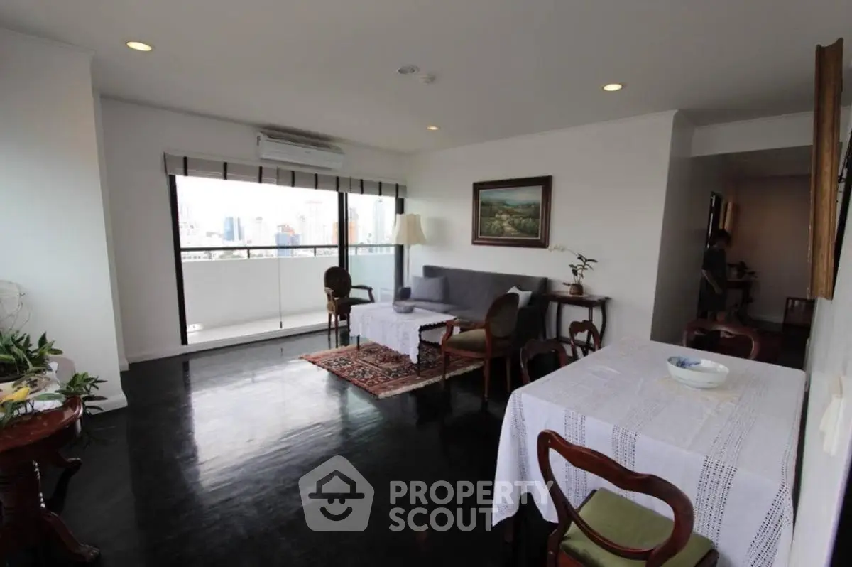 Spacious living room with elegant decor and city view balcony