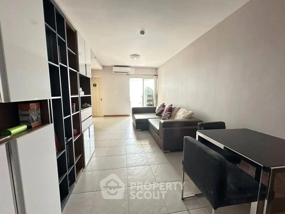 Spacious living room with modern furniture and open layout, perfect for relaxation and entertainment.