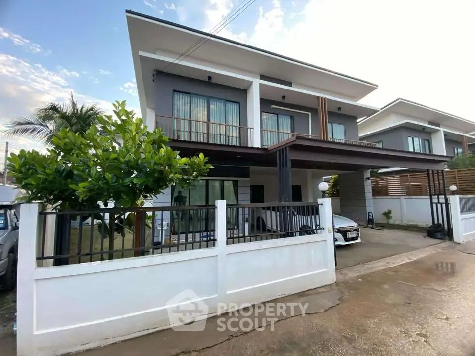 Modern two-story house with sleek design and spacious driveway in a serene neighborhood.