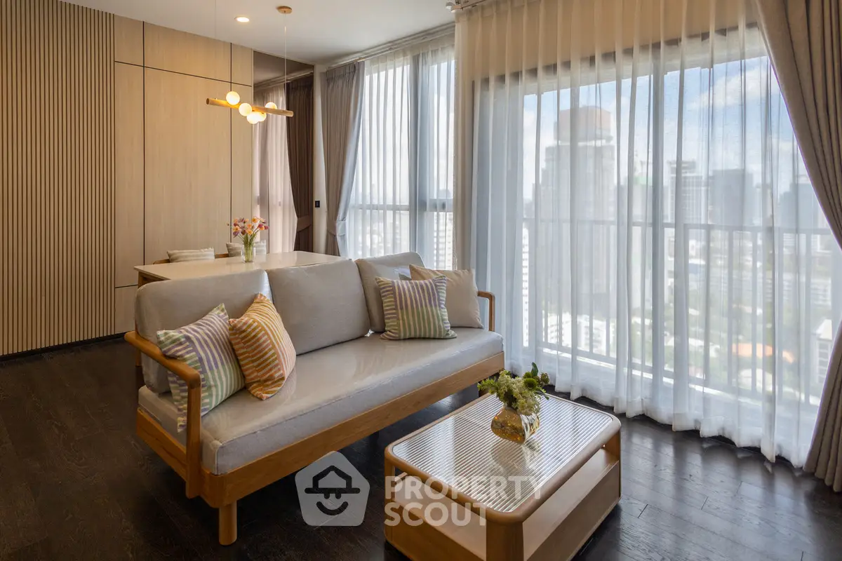 Modern living room with city view, stylish furniture, and natural light