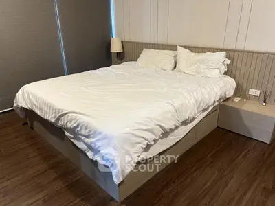 Modern bedroom with wooden flooring and stylish bed in cozy apartment