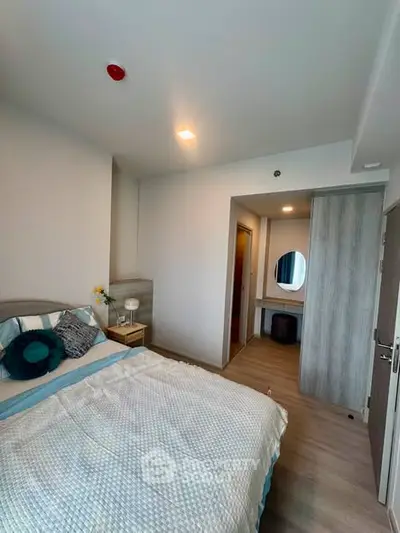Cozy bedroom with modern decor and soft lighting, featuring a comfortable bed and stylish furnishings.