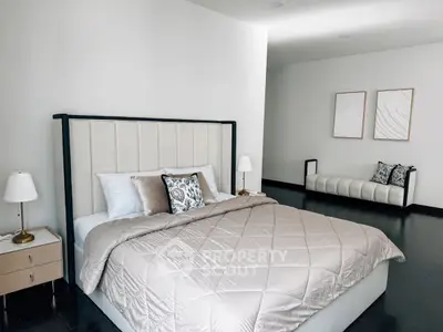Luxurious bedroom with elegant decor and stylish furnishings, featuring a plush bed and modern lighting.