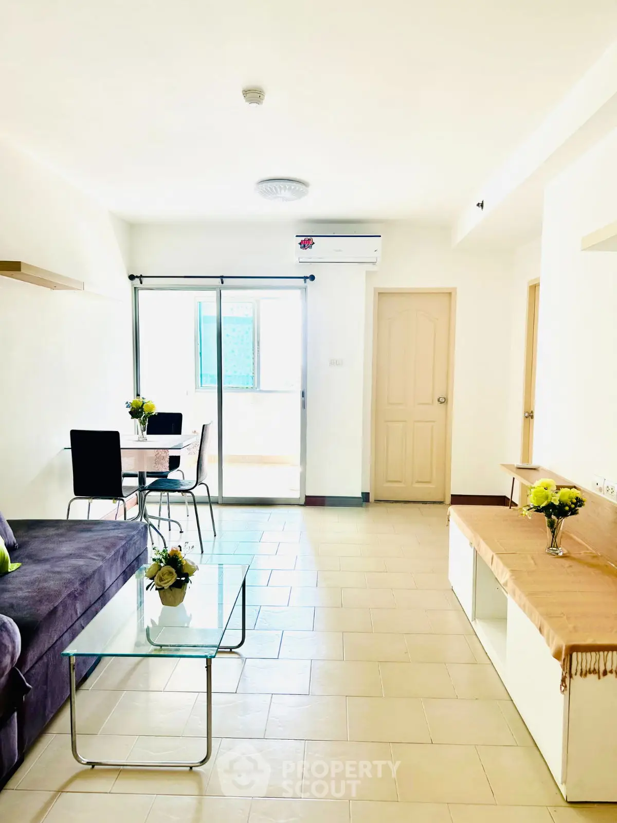 Bright and airy living room with modern furniture and glass coffee table