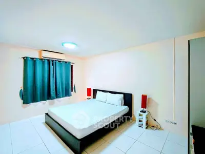 Spacious bedroom with modern decor and natural light in a stylish apartment.