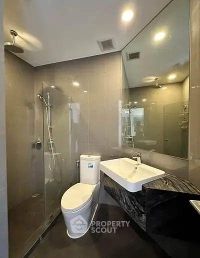 Modern bathroom with sleek fixtures and glass shower enclosure