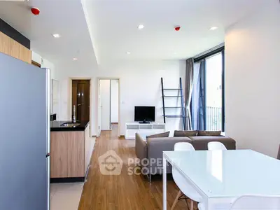 Modern open-plan living room with sleek kitchen and stylish furniture