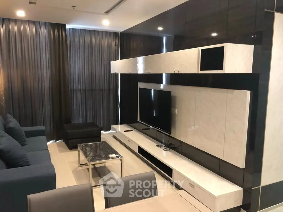 Modern living room with sleek furniture and large TV setup