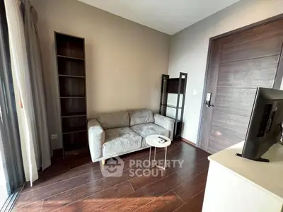 Modern living room with cozy gray sofa and sleek wooden flooring