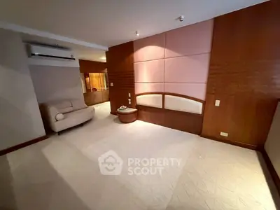 Spacious living room with modern design and cozy seating area.