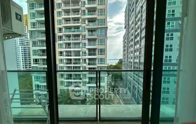 Stunning balcony view of modern high-rise buildings with a glimpse of the sea.