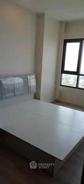 Modern bedroom with large window and minimalist design