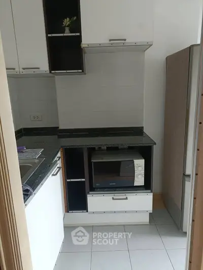 Compact kitchen with modern appliances and sleek cabinetry