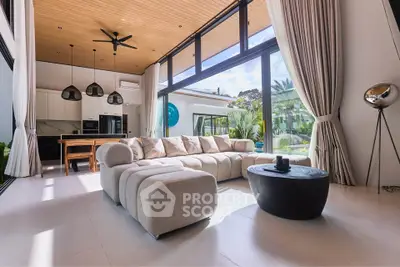 Luxurious modern living room with high ceilings and large windows offering stunning garden views.