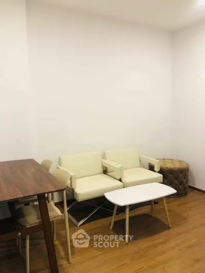 Modern living room with minimalist furniture and wooden flooring, perfect for cozy gatherings.