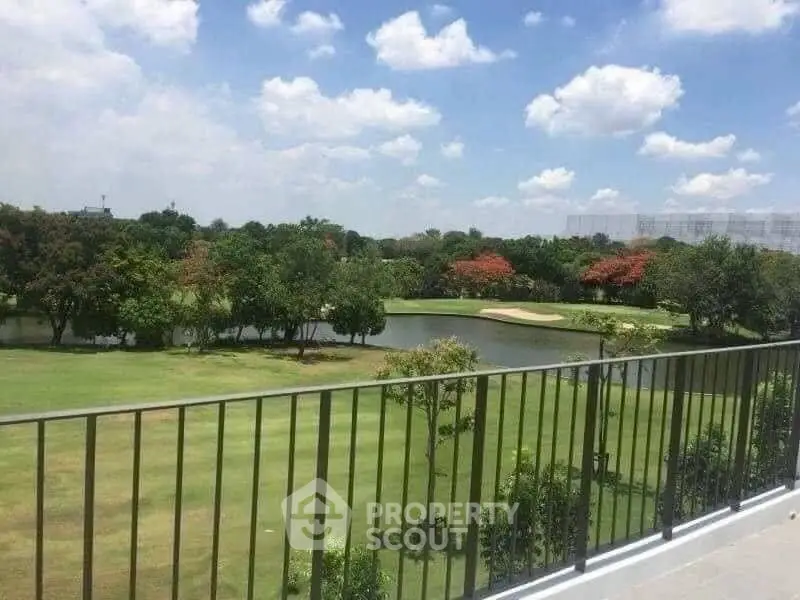 Stunning golf course view from spacious balcony in luxury property.
