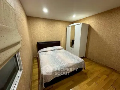 Cozy bedroom with wooden flooring and modern wardrobe