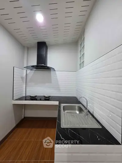 Modern kitchen with sleek black countertops and gas stove