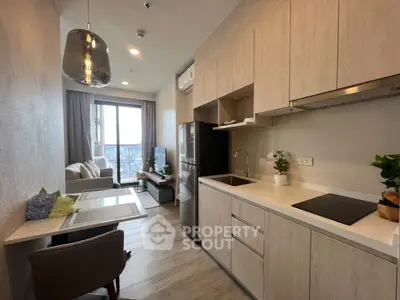 Modern open-layout kitchen and living area with city view