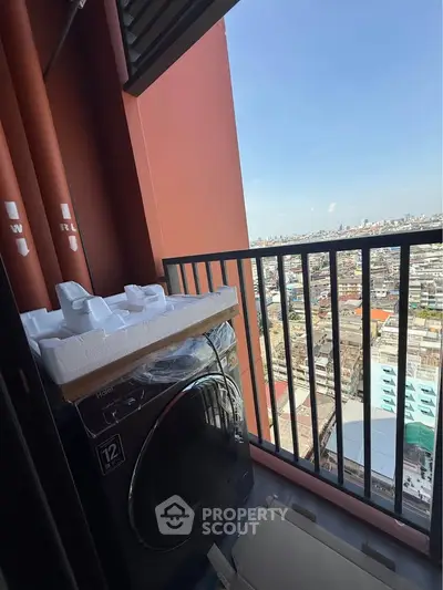 High-rise balcony with city view and washing machine setup